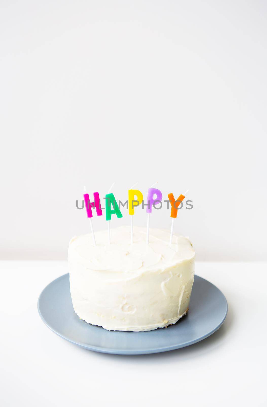 Birthday cake, on a creamy sponge cake the inscription happiness. The concept of the holiday and birthday surprise