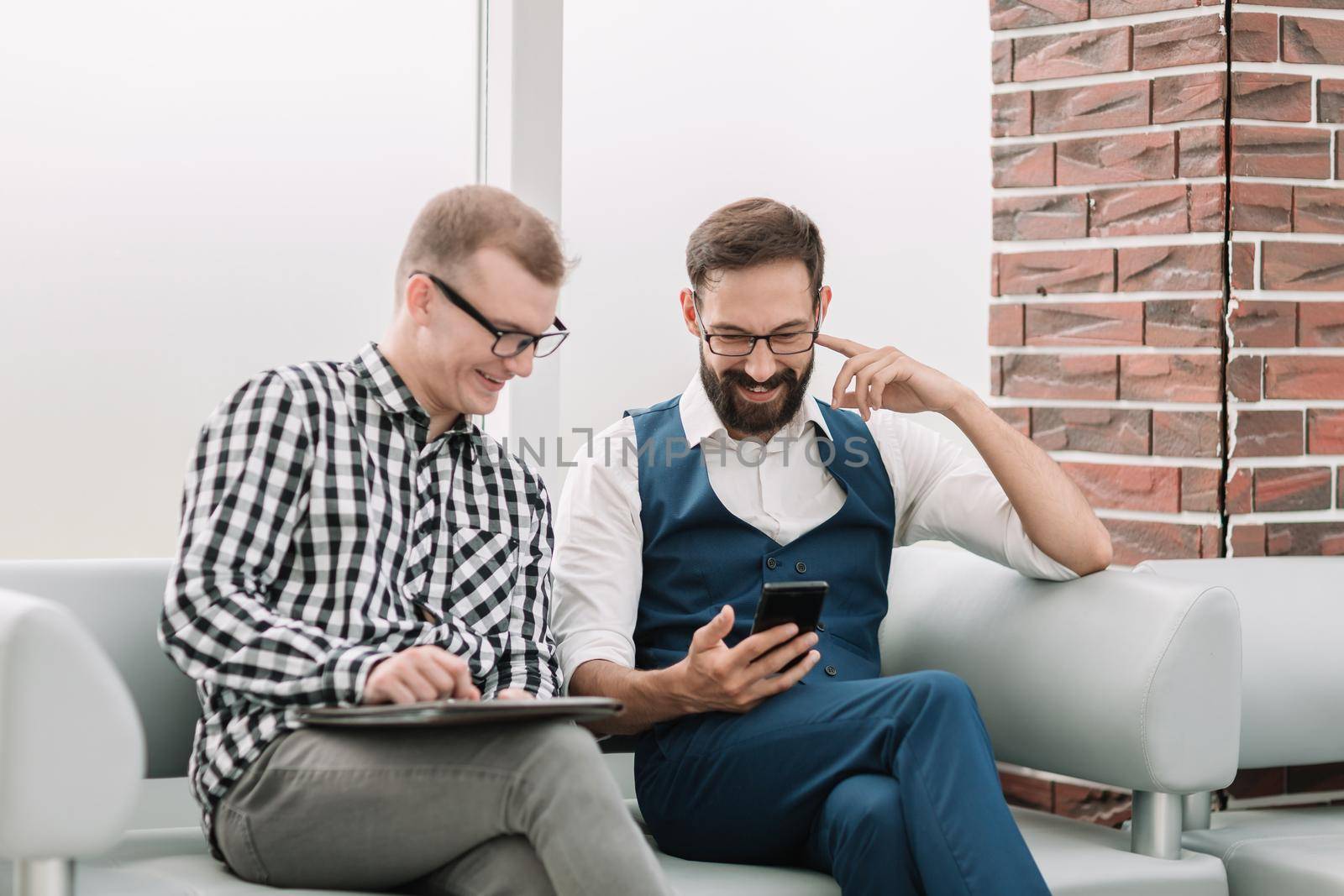 two employees looking at the smartphone screen.people and technology