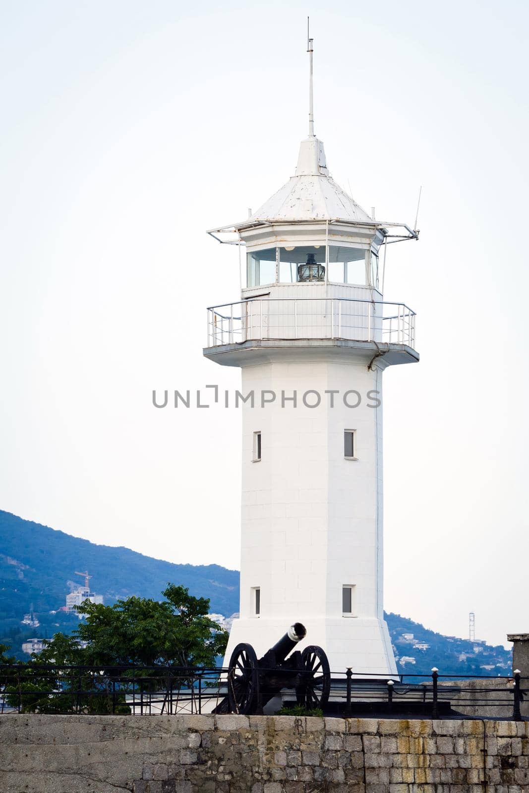 Lighthouse with an old cannon. by dmitryz