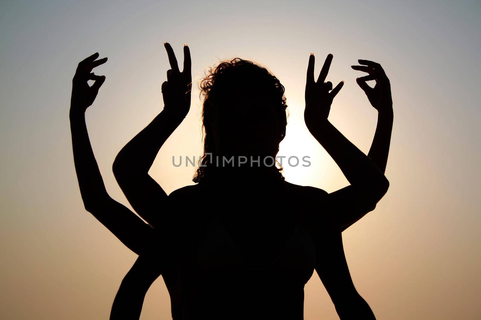 Girls silhouettes with arms raised up outdoor by dmitryz