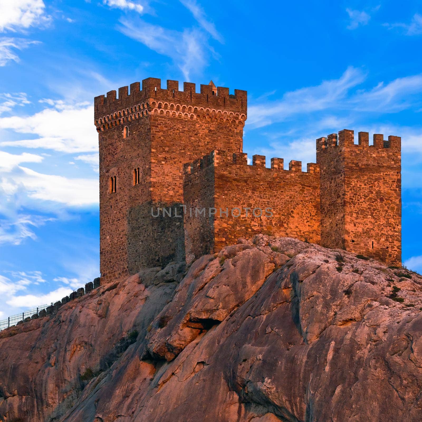 Medieval Genoese fortress against blue sky with clouds. The Crimean Peninsula, Ukraine.