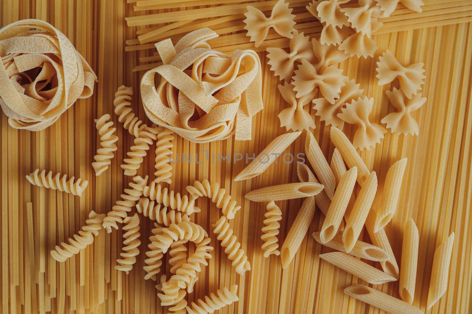 Different Types of Pasta Laid Out on Background of Spaghetti