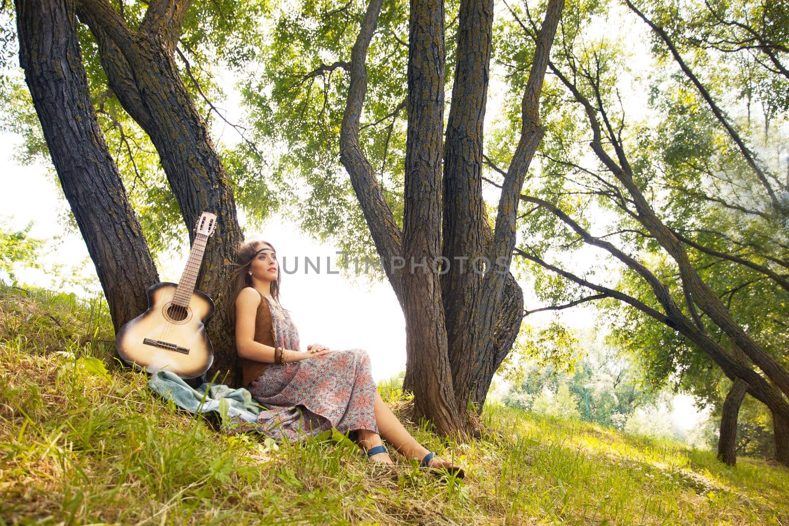 Beautiful young hippie girl has a rest on the nature.