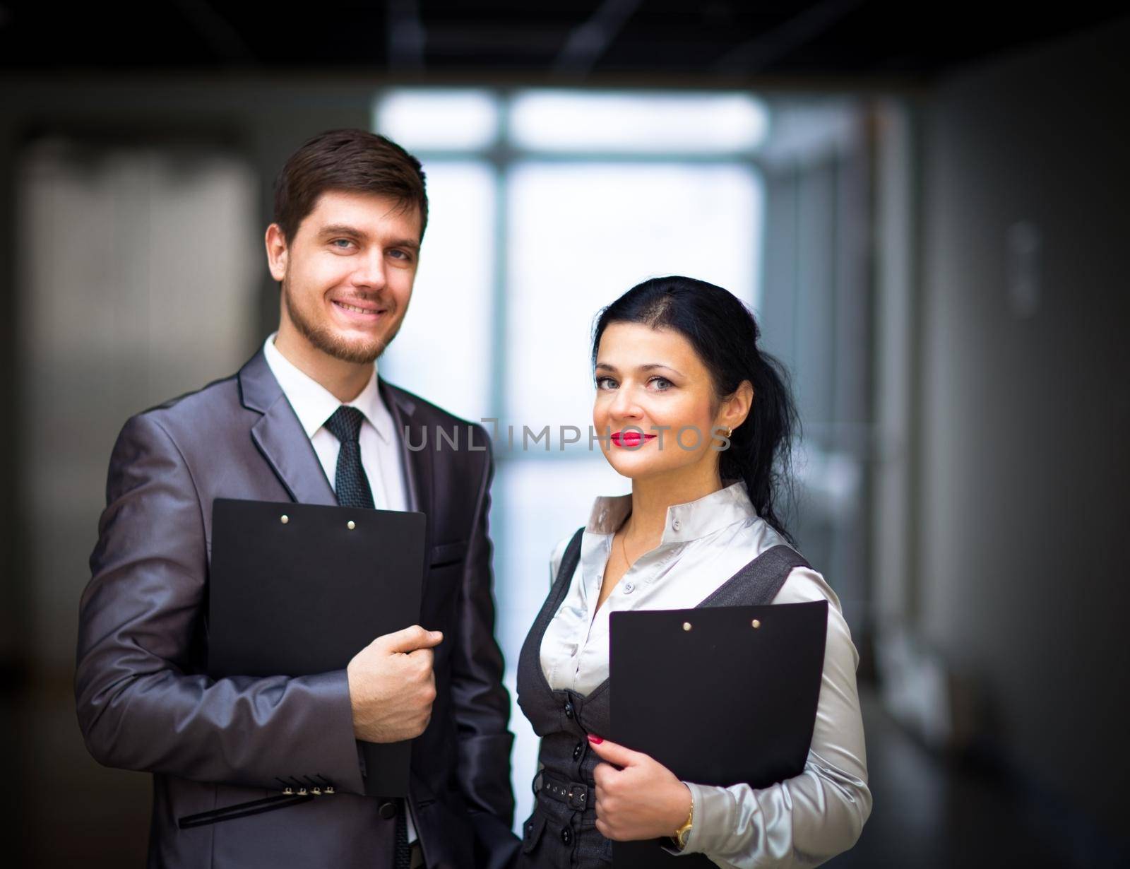 smiling employees standing around their manager