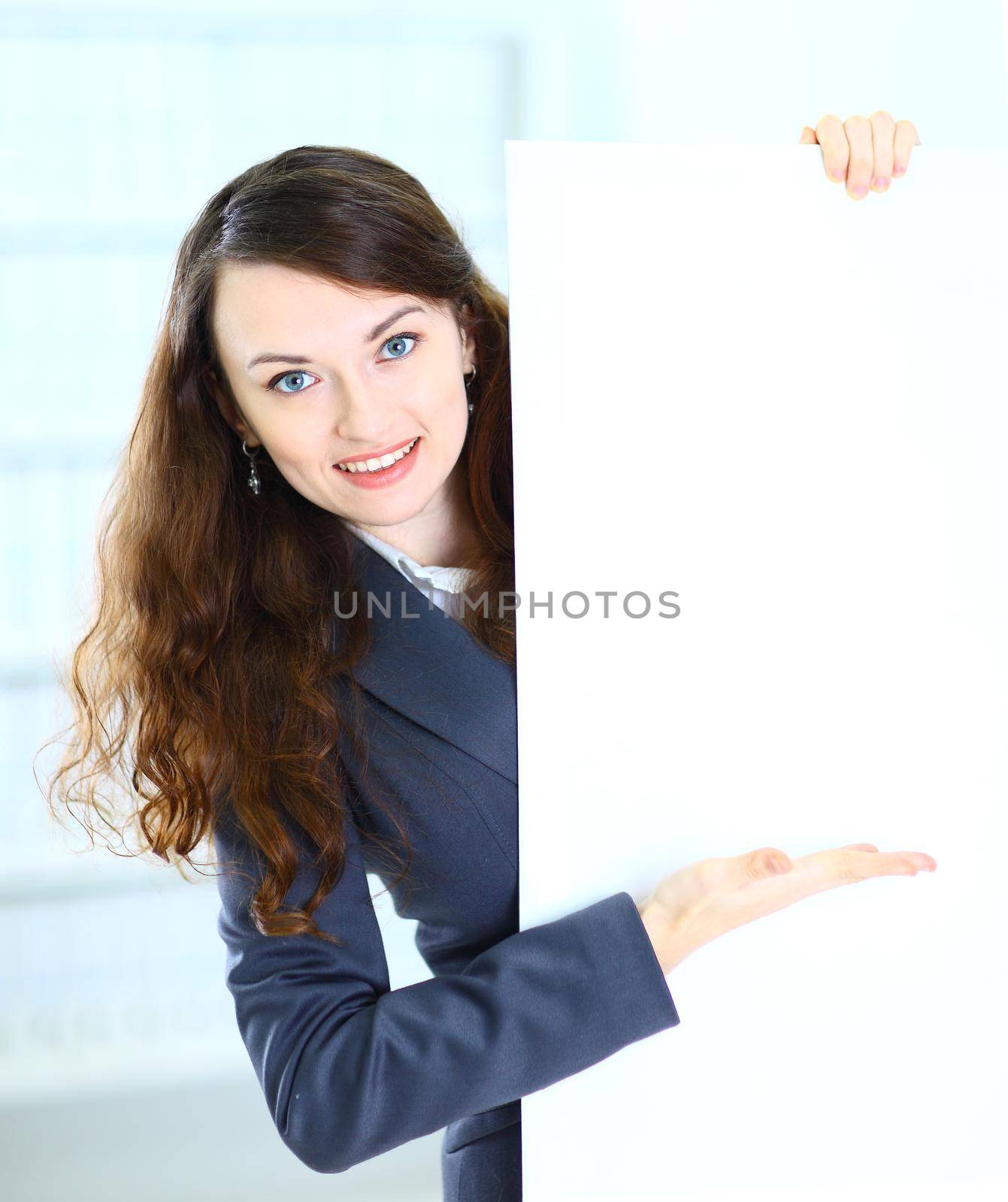 Happy smiling young business woman showing blank signboard, isolated on white background