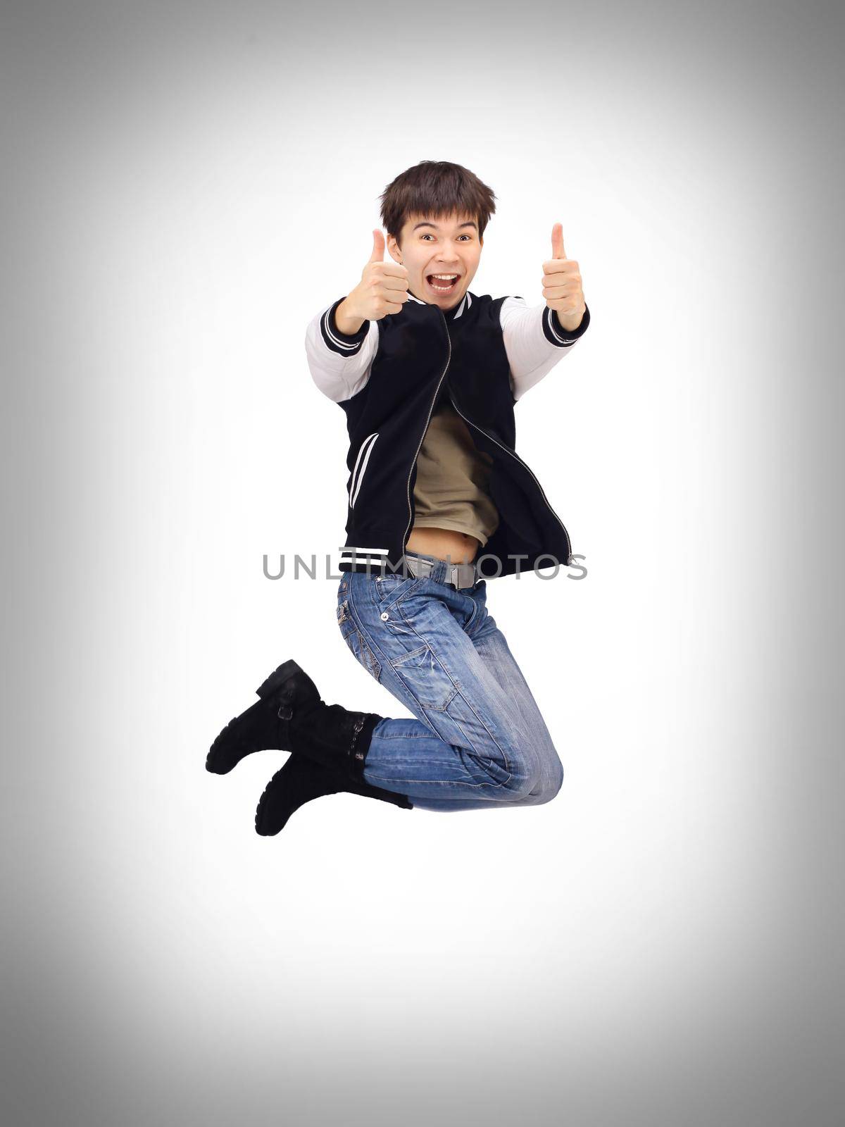 Young trendy stylish teenager jumping in joy isolated over white background. by SmartPhotoLab