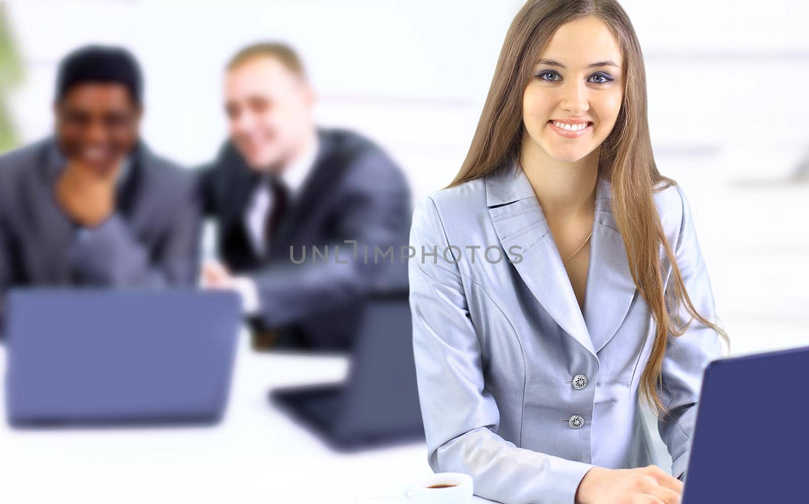Beautiful businesswoman keeps the laptop. Isolated on a white background.