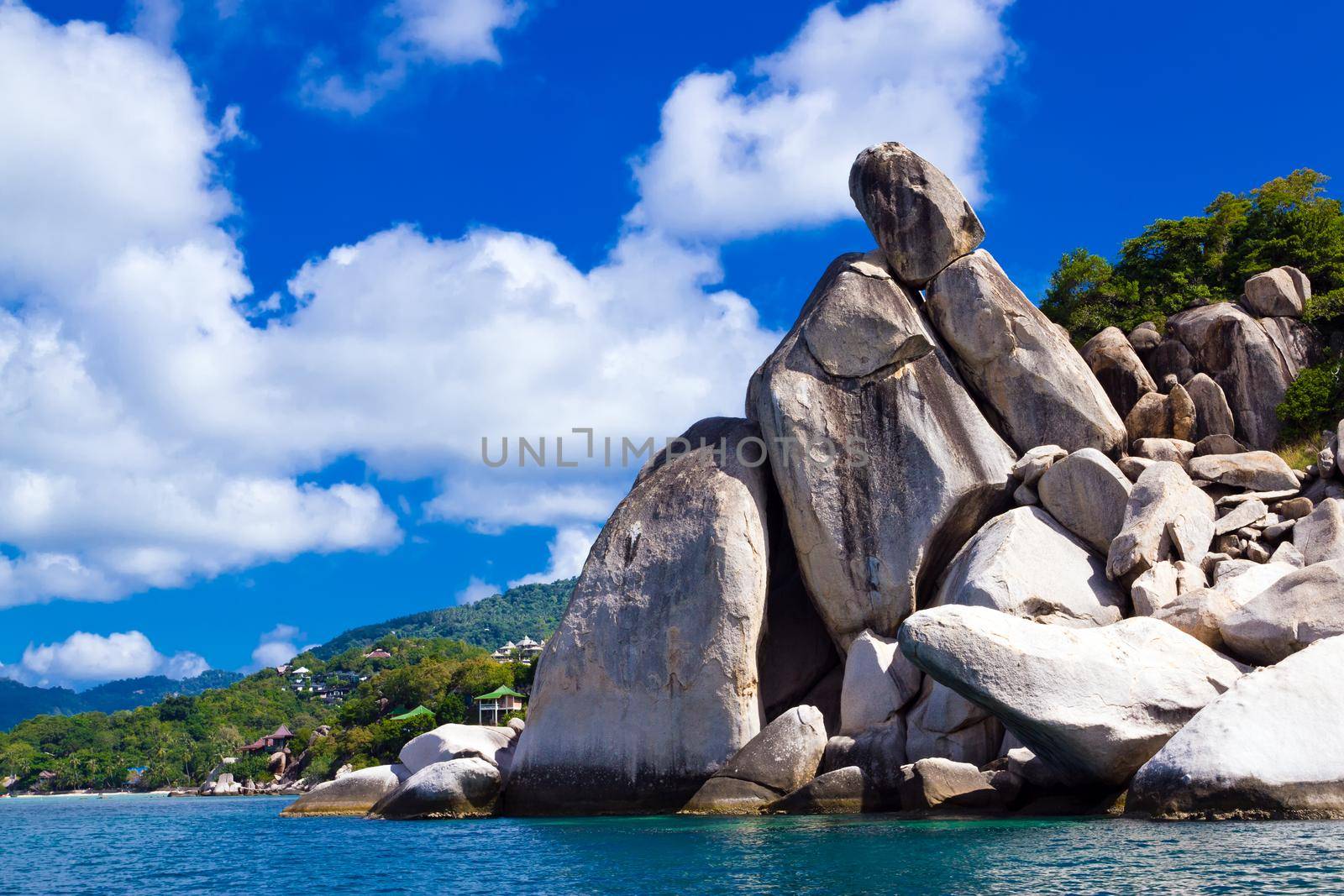 Stoned island coastline against blue sky with clouds. Koh Tao is by dmitryz