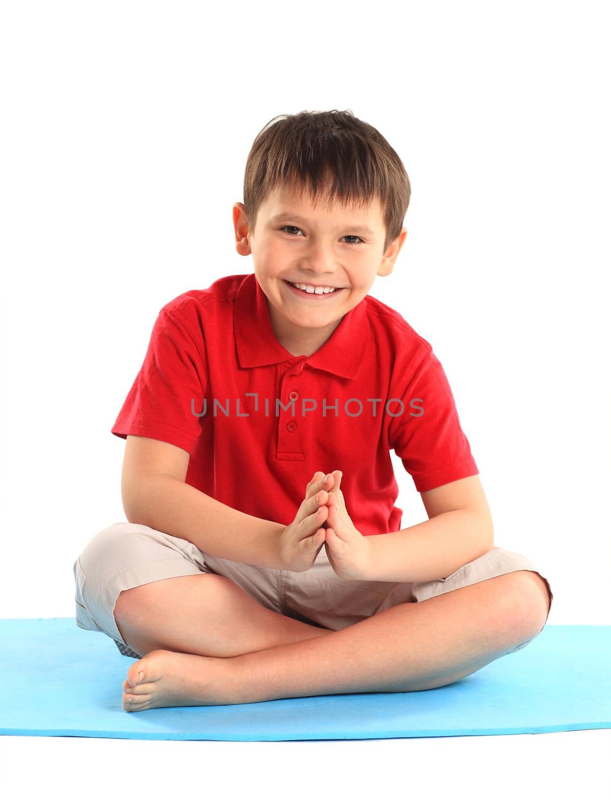 Children's yoga. The little boy does exercise.