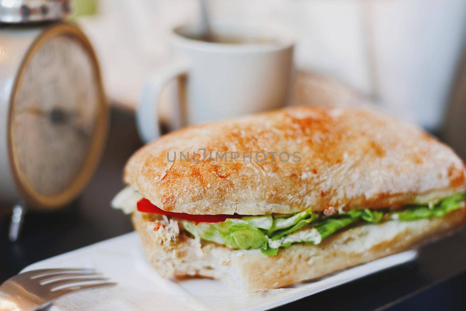 Time for lunch with big tasty sandwich and cup of coffee. Hamburger and hot beverage for coffee break.