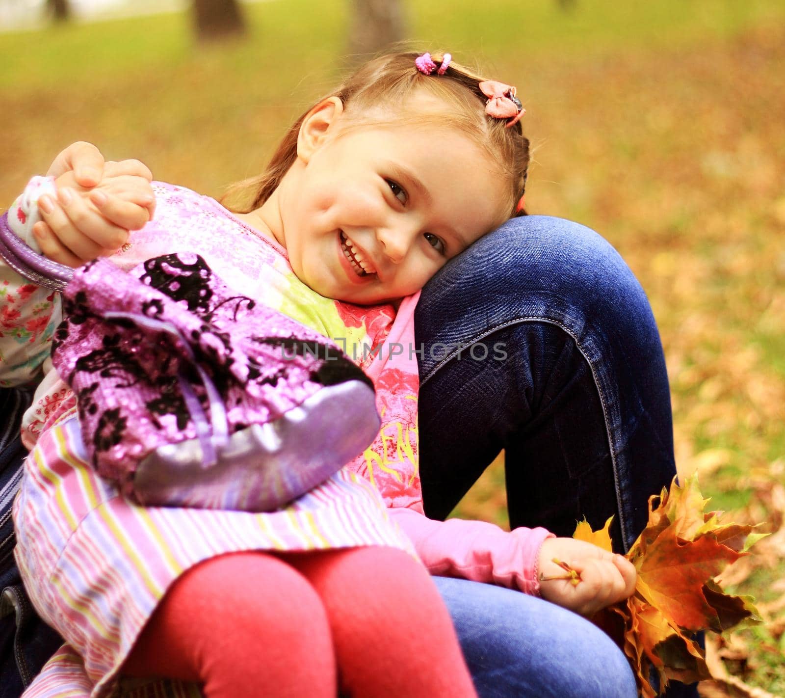 Cute little girl on the meadow in summer day