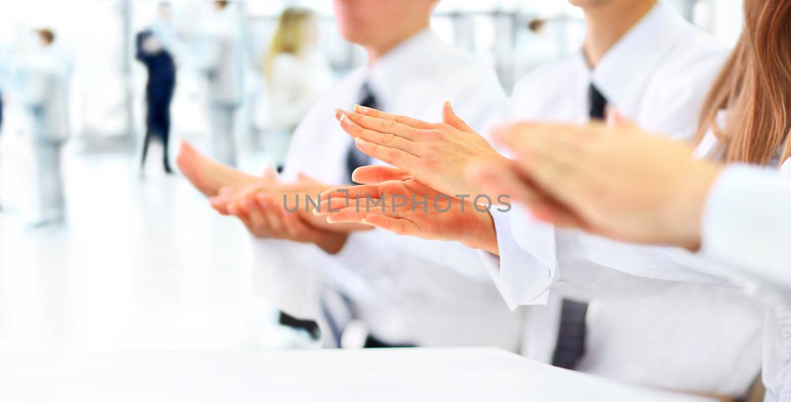 Close-up of business people clapping hands. Business seminar concept