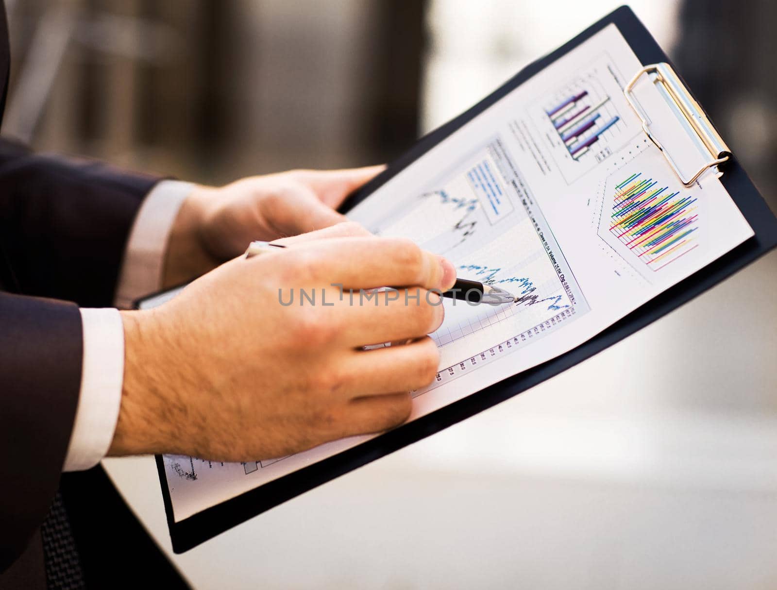 Close-up of female and male hands pointing at business document while discussing it