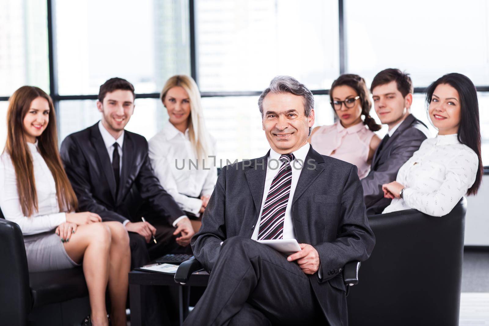 A group of businessmen discussing the policy of the company in the office.