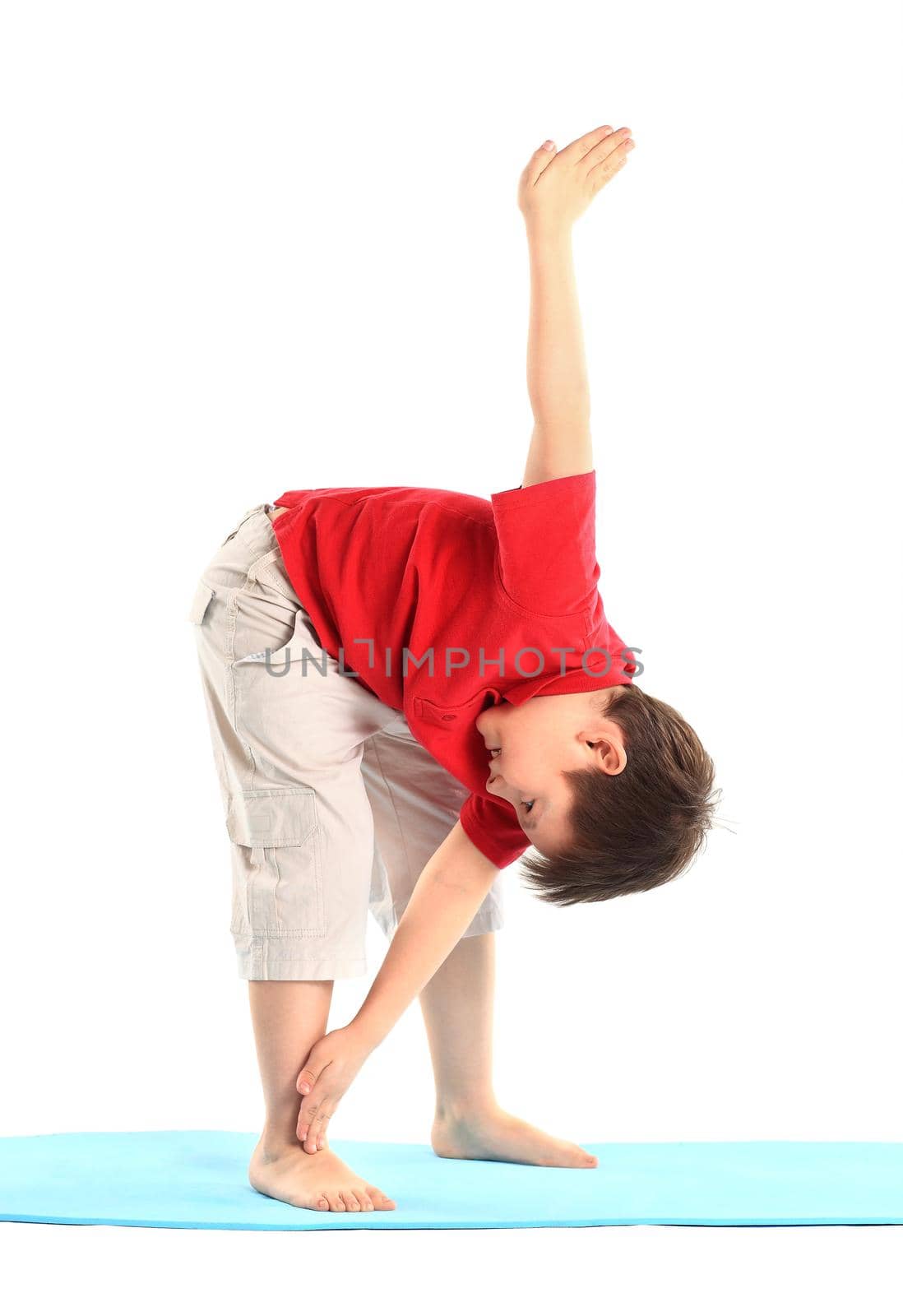 Children's yoga. The little boy does exercise. by SmartPhotoLab