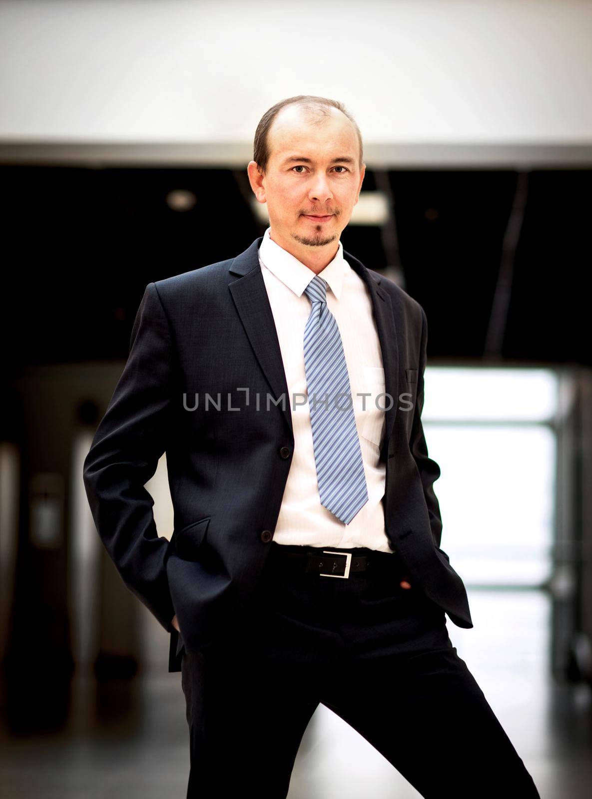 Happy mature business man looking at camera with satisfaction at office