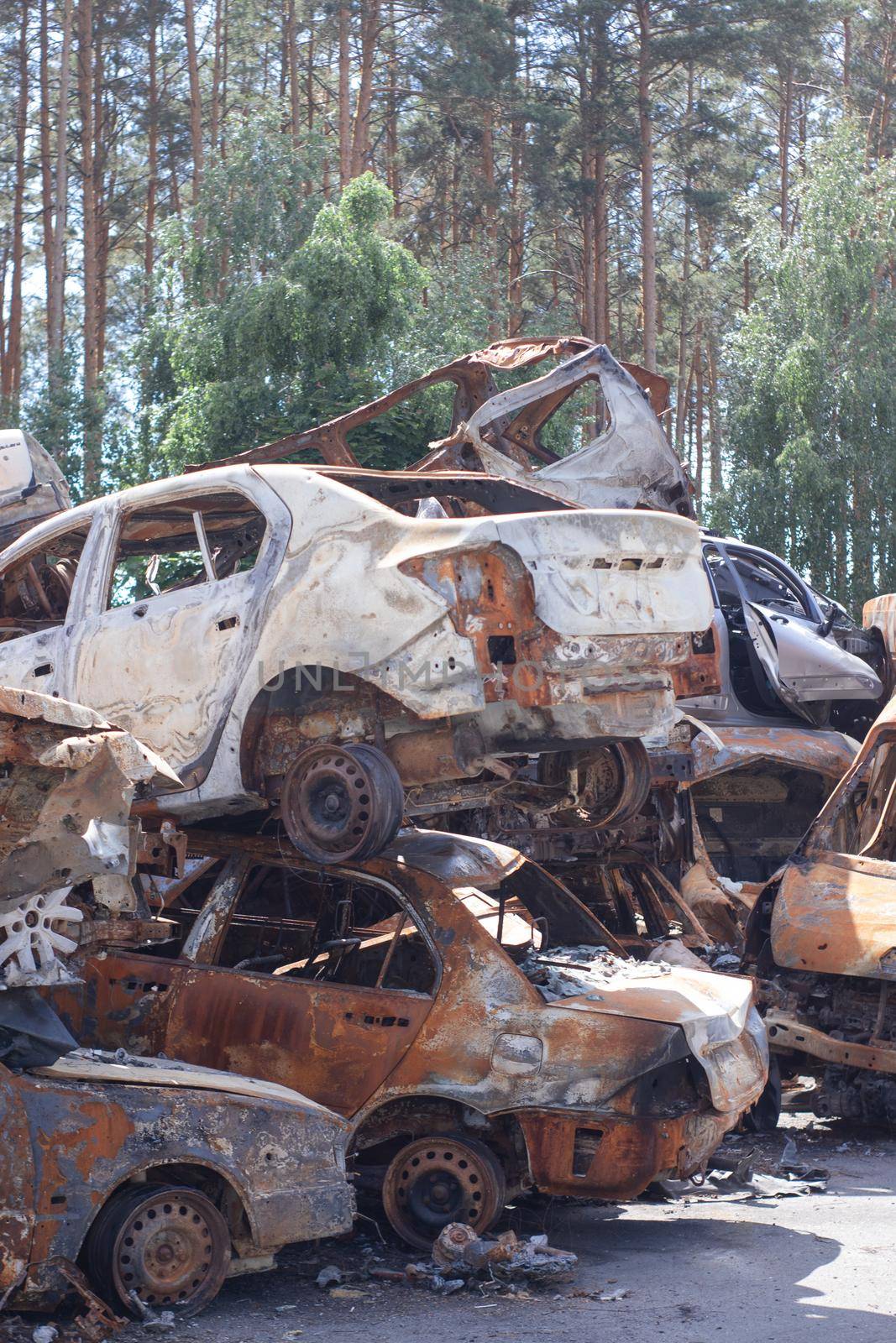 war in ukraine. Car graveyard. Shot cars of civilians. russia's war against Ukraine. Burnt and blown up car. Cars damaged after shelling. irpin bucha. war crimes.