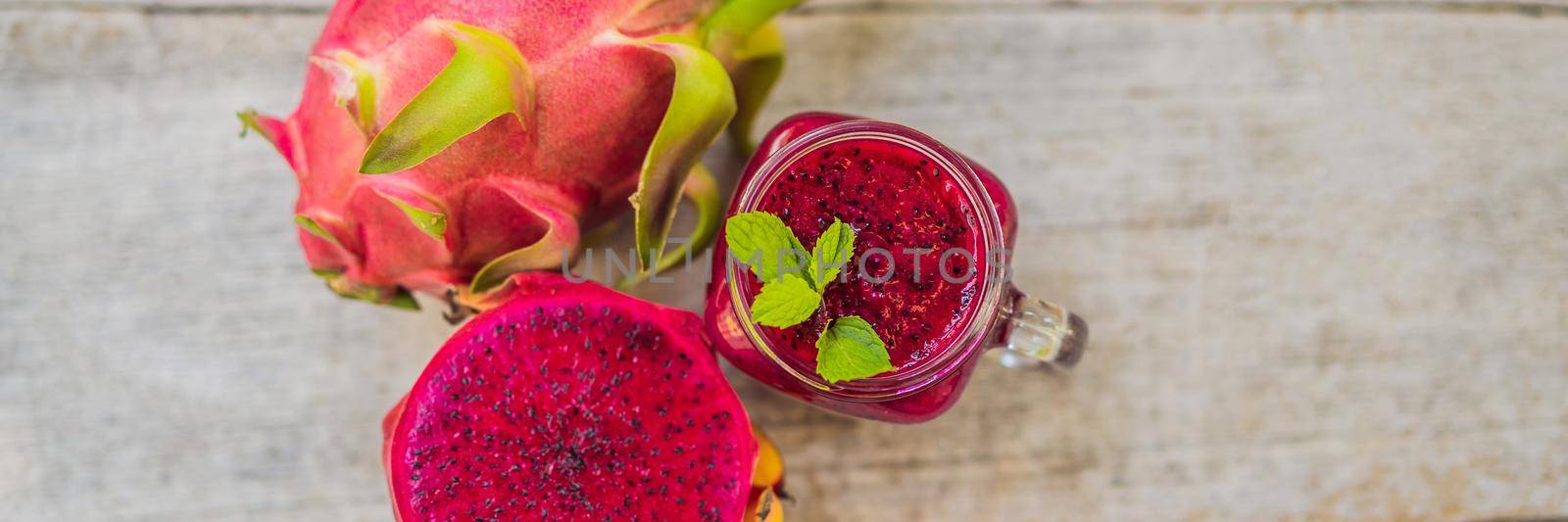 Dragon fruit smoothie on a wooden background. BANNER, LONG FORMAT