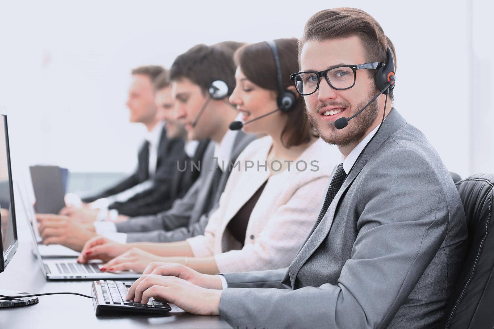 operator call center with colleagues sitting at the workplace by asdf