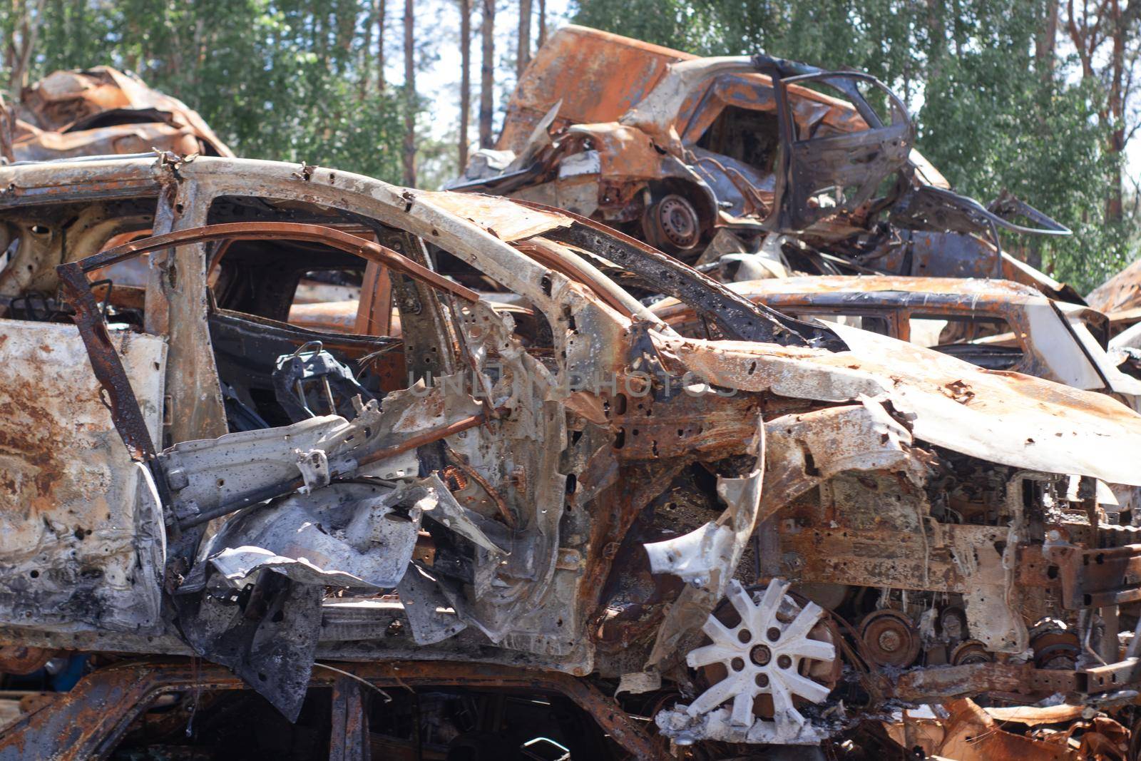 war in ukraine. Car graveyard. Shot cars of civilians. russia's war against Ukraine. Burnt and blown up car. Cars damaged after shelling. irpin bucha. war crimes.