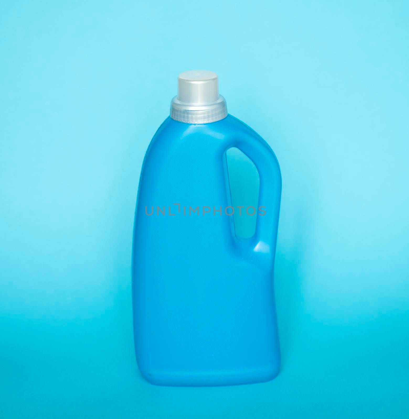Big Blue plastic bottles of cleaning products isolated on blue background. Mock up. Product design
