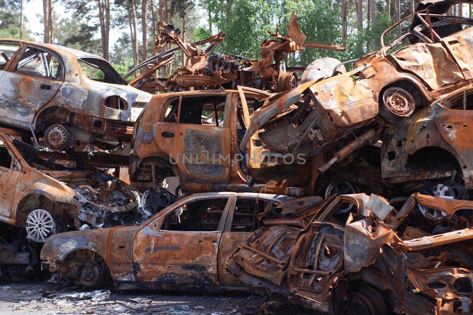 war in ukraine. Car graveyard. Shot cars of civilians. russia's war against Ukraine. Burnt and blown up car. Cars damaged after shelling. irpin bucha. war crimes.