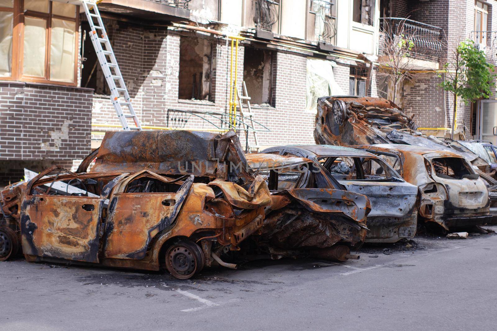 war in ukraine. Car graveyard. Shot cars of civilians. russia's war against Ukraine. Burnt and blown up car. Cars damaged after shelling. irpin bucha. war crimes.