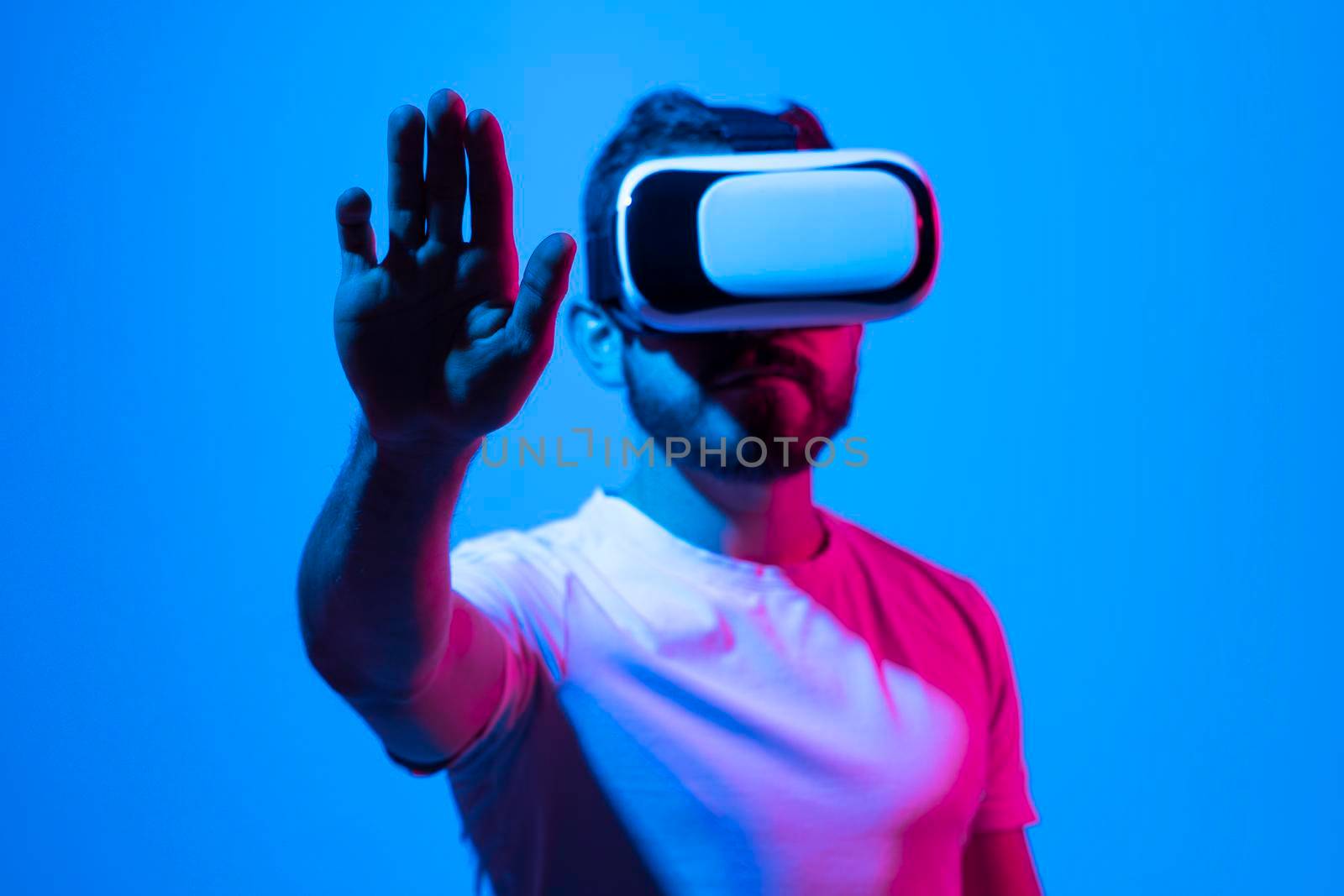 Modern architect, designer using virtual reality glasses at workplace. Designer working in augmented reality vr studio. Man working in VR goggles on a studio background