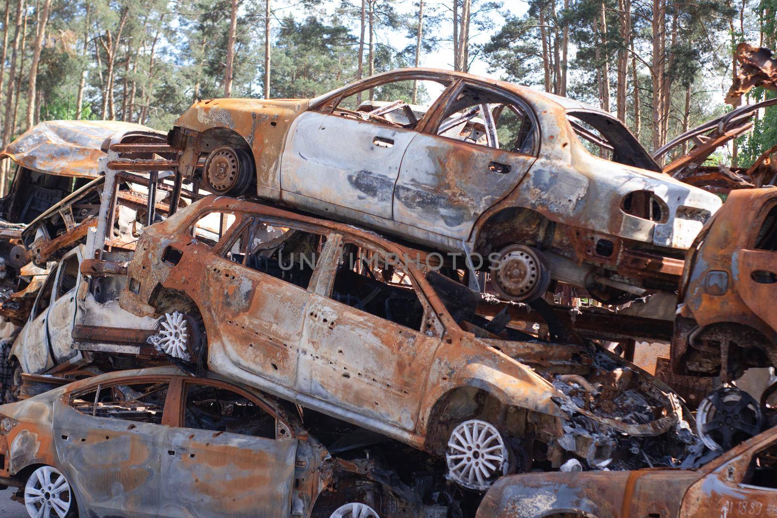 war in ukraine. Car graveyard. Shot cars of civilians. russia's war against Ukraine. Burnt and blown up car. Cars damaged after shelling. irpin bucha. war crimes.