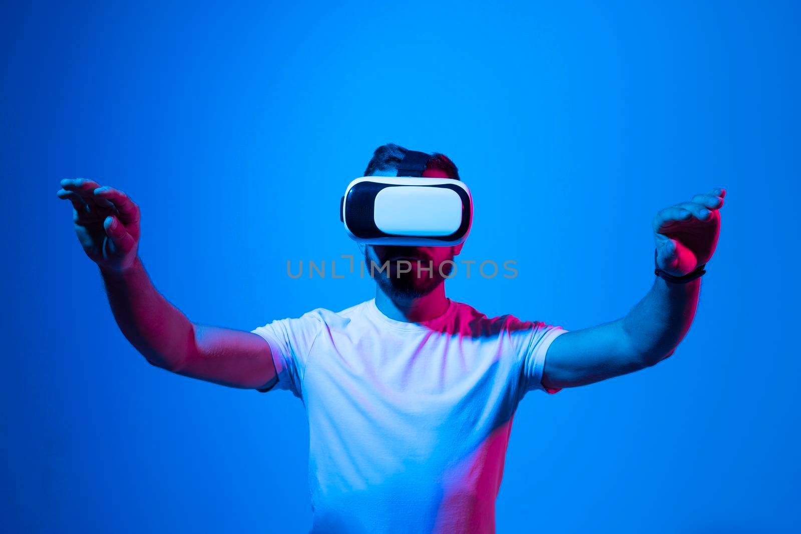 Modern architect, designer using virtual reality glasses at workplace. Designer working in augmented reality vr studio. Man working in VR goggles on a studio background