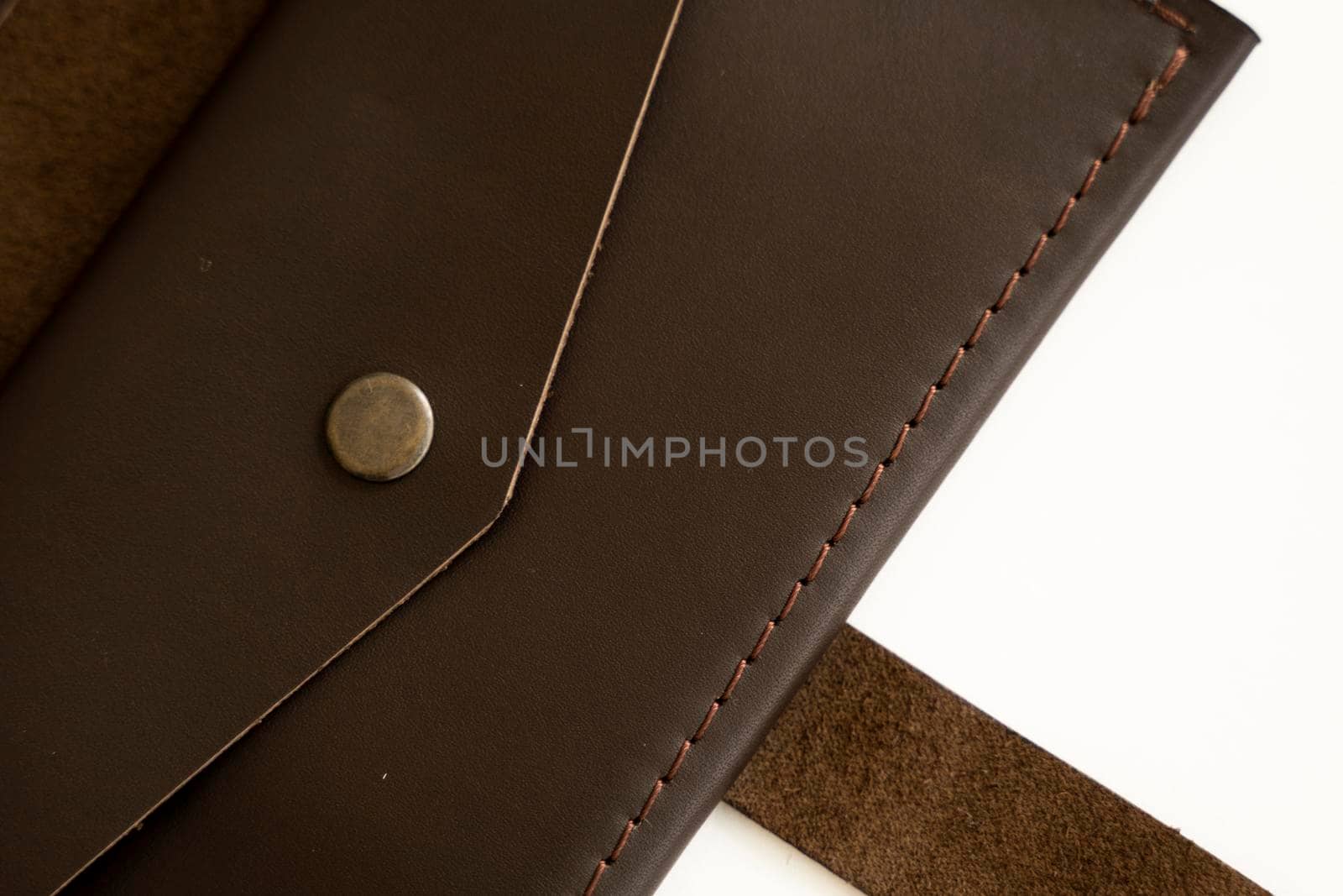 Top view of brown empty man's black handmade genuine leather wallet for banknotes and credit cards isolated on white background. Selective focus, copy space, Close up. by vovsht