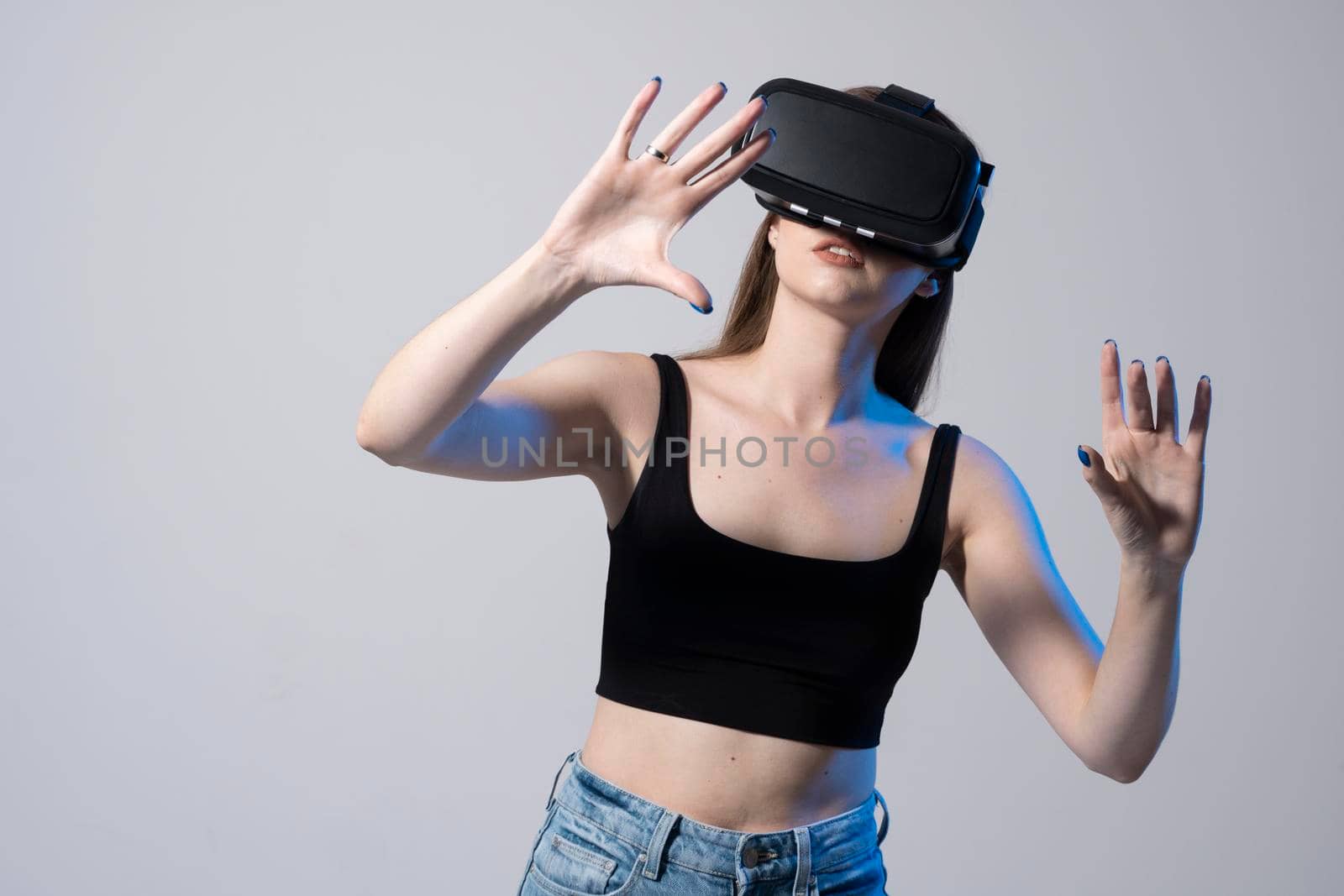 Happy brunette girl getting experience using VR headset glasses of virtual reality