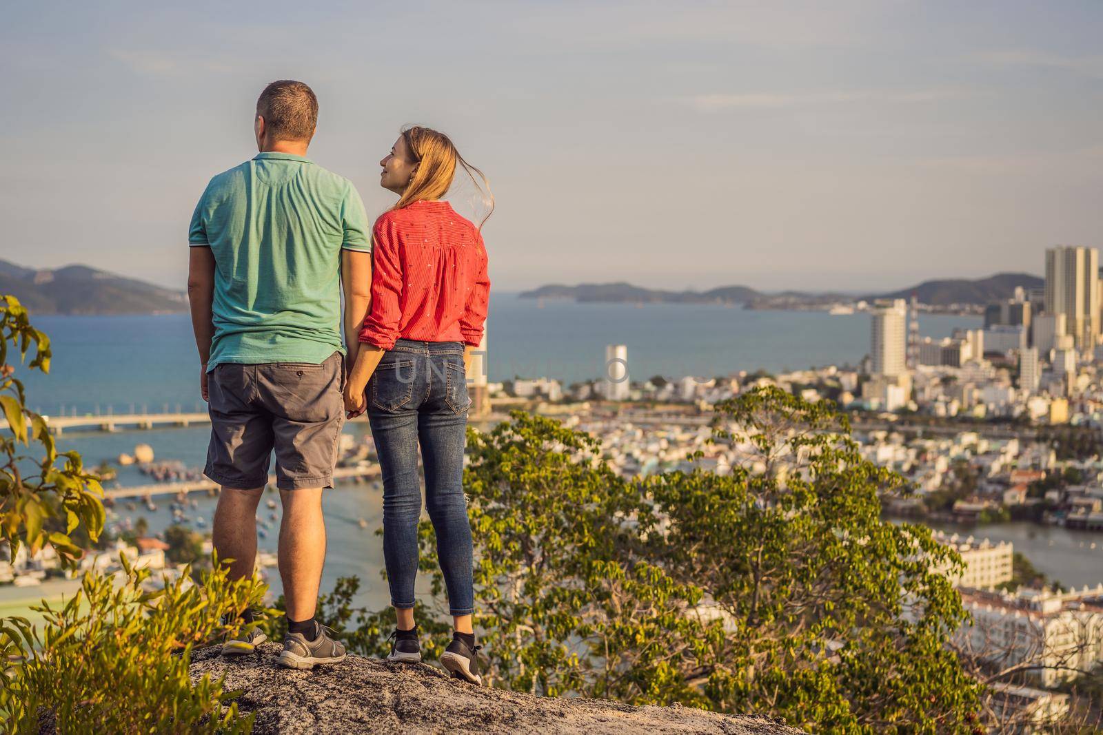 Happy couple tourists on the background of Nha Trang city. Travel to Vietnam Concept by galitskaya