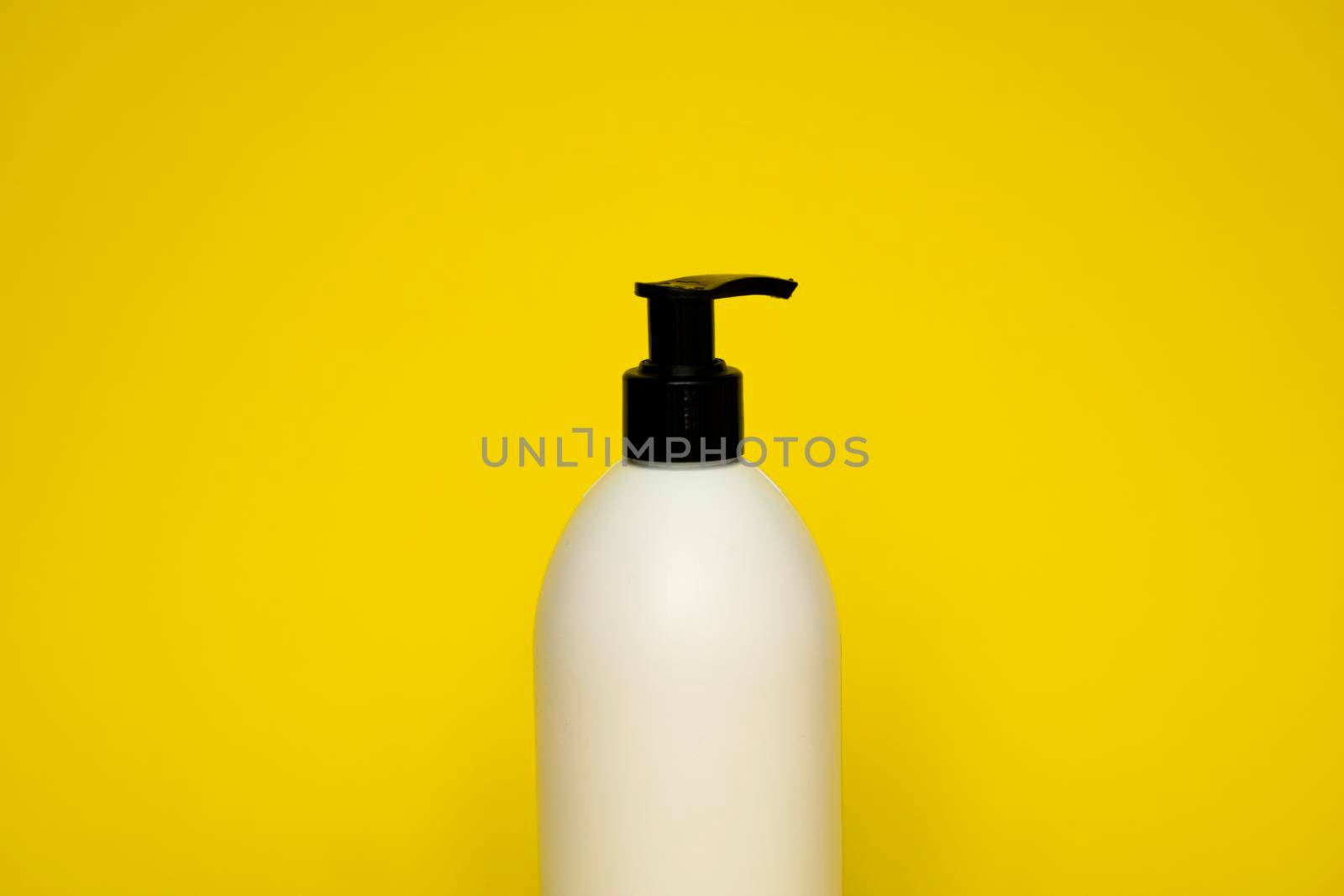 Liquid container for gel, lotion, cream, shampoo, bath foam on yellow background. Cosmetic plastic bottle with white dispenser pump. Mock up template for design. by vovsht