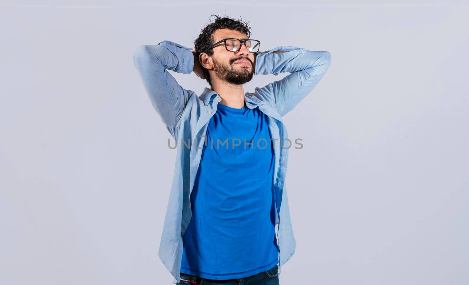 Relaxed smiling guy with hands behind his head, Relaxed man with closed eyes with hands behind his head, Satisfied man with hands behind his head, Concept of relaxed man with free time