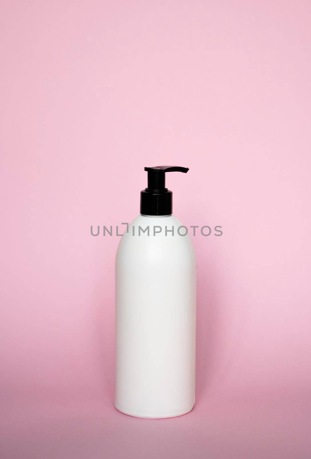 Liquid container for gel, lotion, cream, shampoo, bath foam on pink background. Cosmetic plastic bottle with white dispenser pump. Mock up template for design. by vovsht