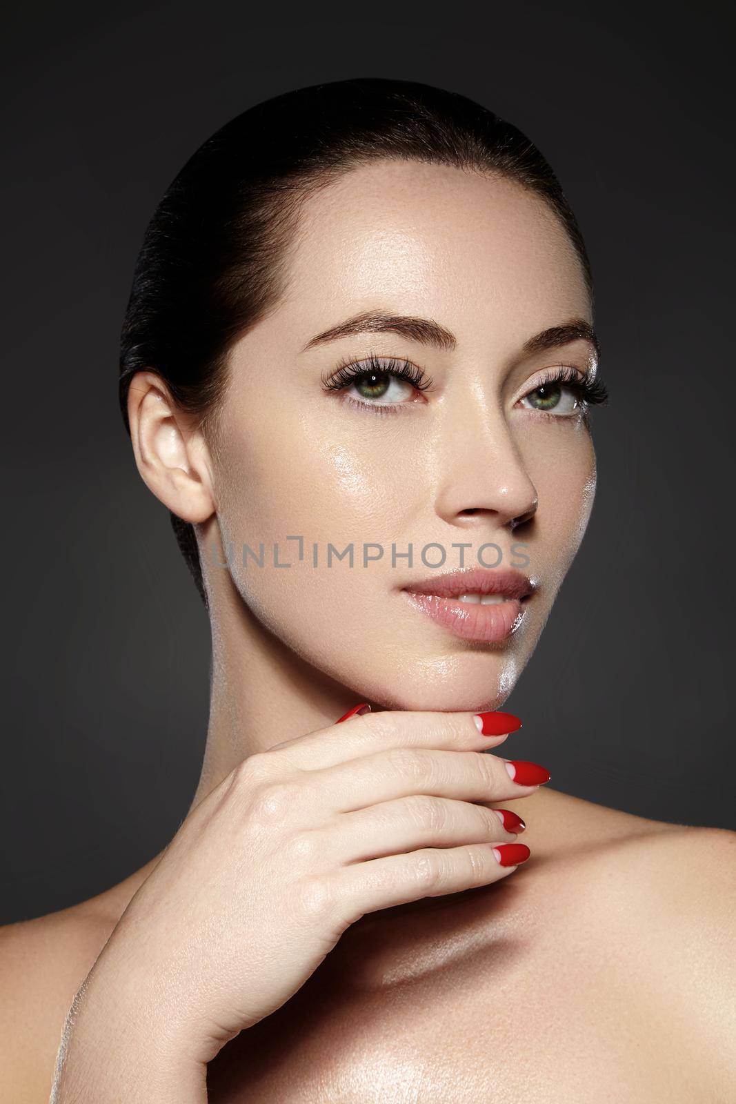 Beautiful woman show her erfect face with fashion make-up. Extreme eyelashes, plump lips, clean skin. Fresh spa look by MarinaFrost