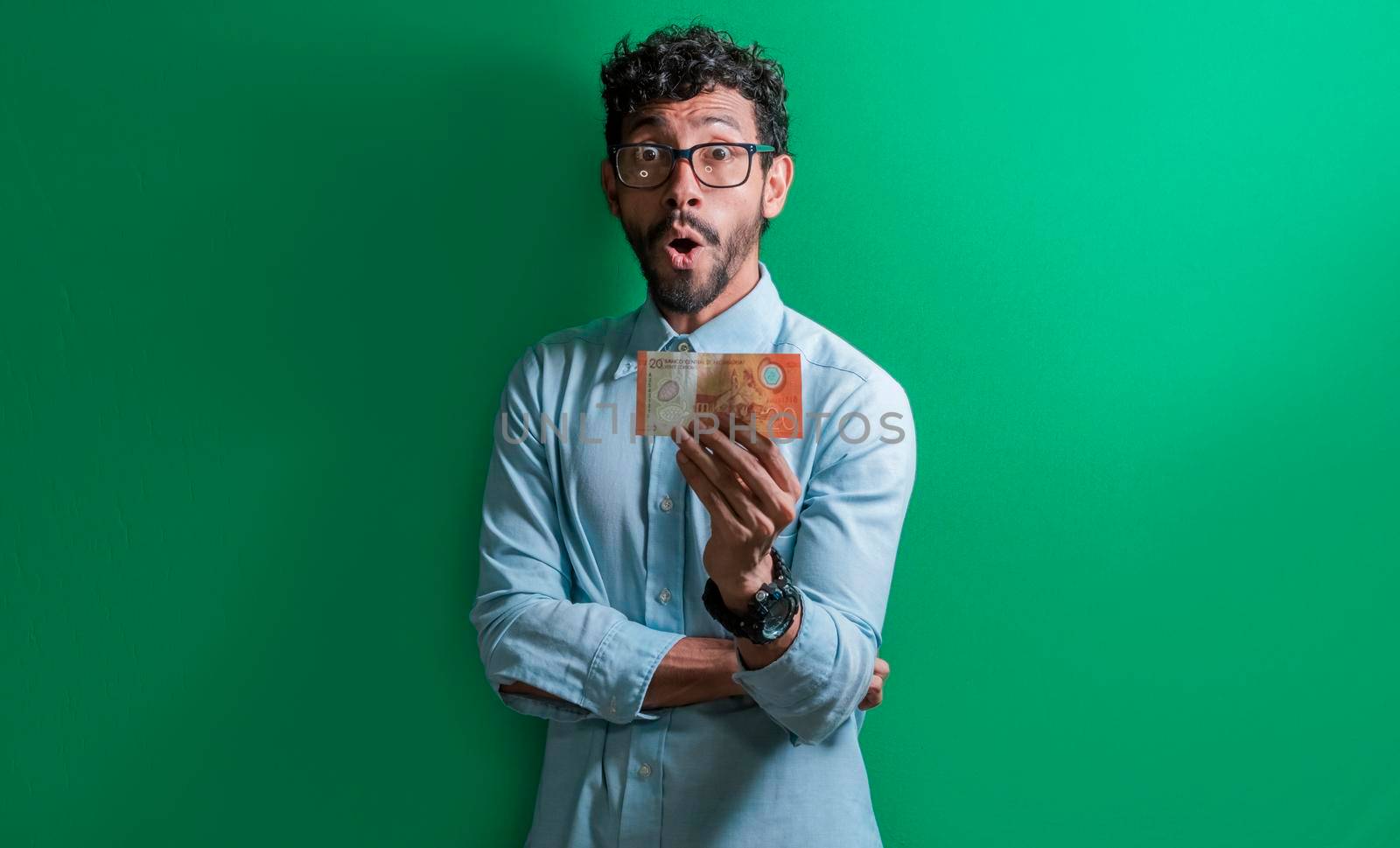 Excited man with money bill in his hands, Latin guy surprised with a money bill in his hands.