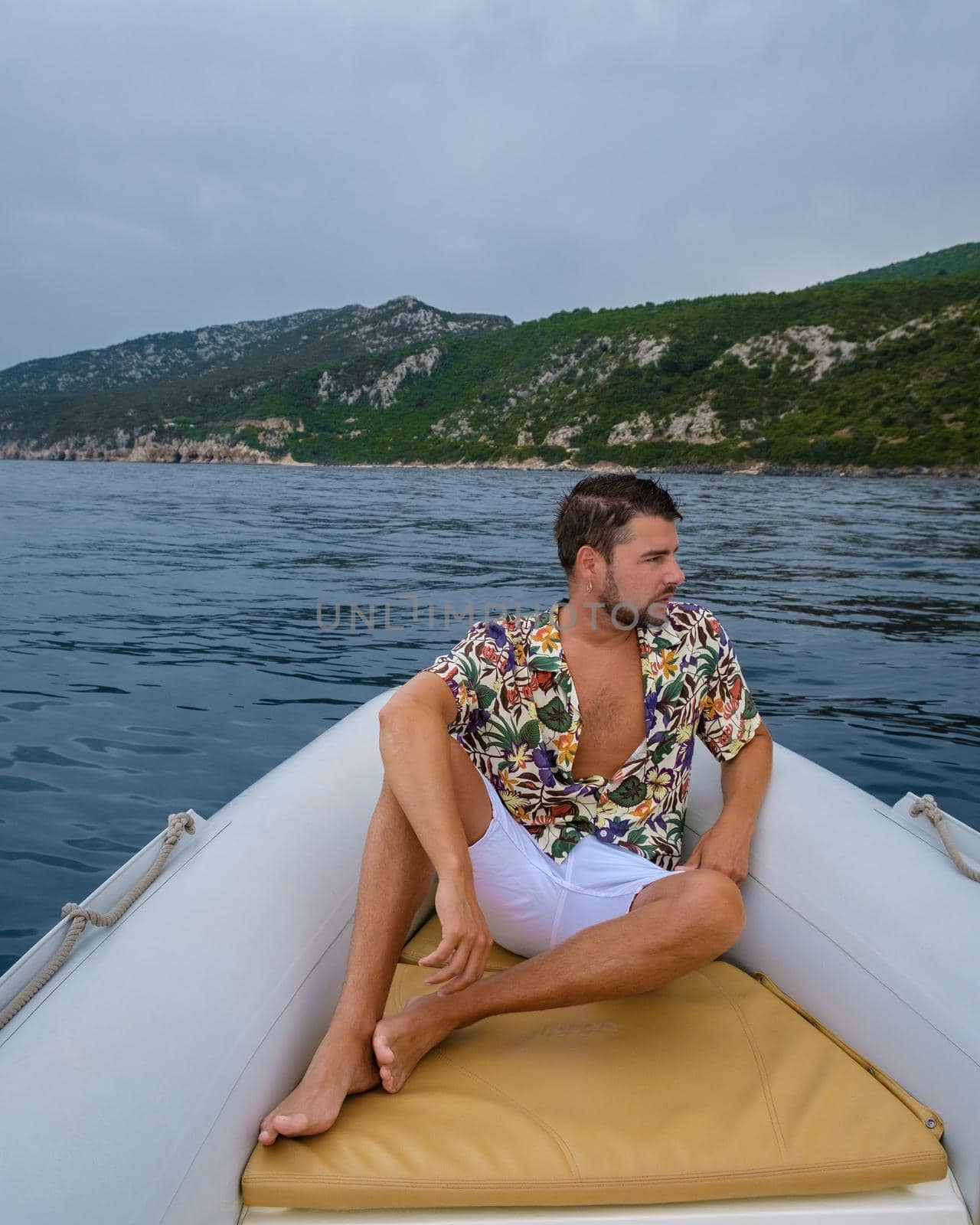 Golfo di Orosei Sardina, Men on the beach chilling in speed boat Sardinia Italy, young guy on vacation Sardinia Italy, man playing in the ocean with crystal clear blue water, by fokkebok