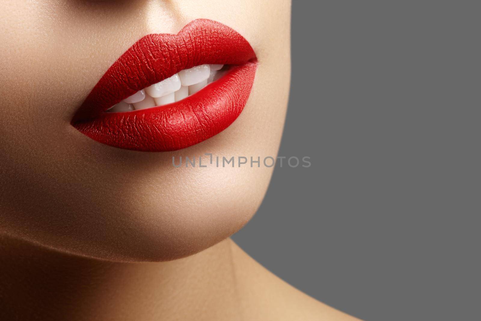 Cosmetics, makeup. Bright lipstick on lips. Closeup of beautiful female mouth with red and pink lip makeup. Part of face by MarinaFrost