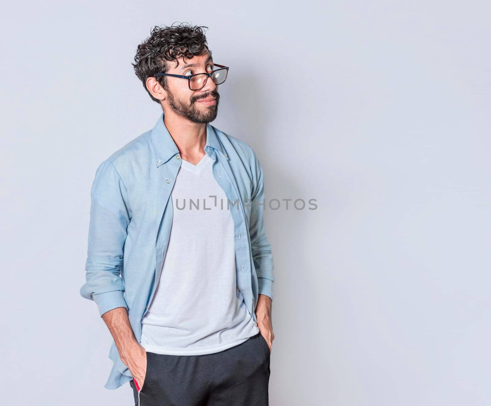young man wondering with hand in pocket over isolated background, handsome guy thinking looking to side