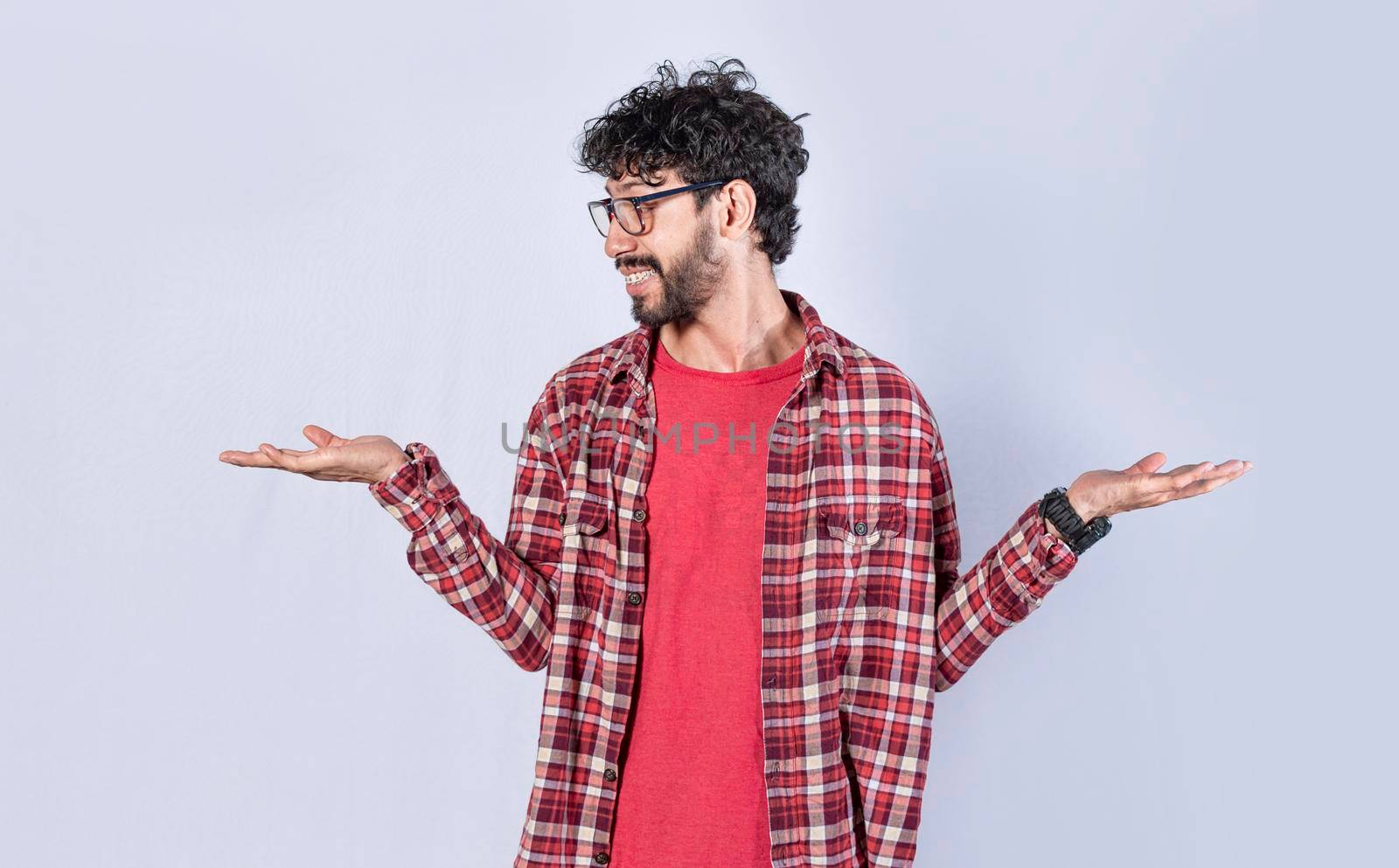 Man balancing the palms of his hands ,man comparing with the palms of his hands, a guy balancing the palms of his hands