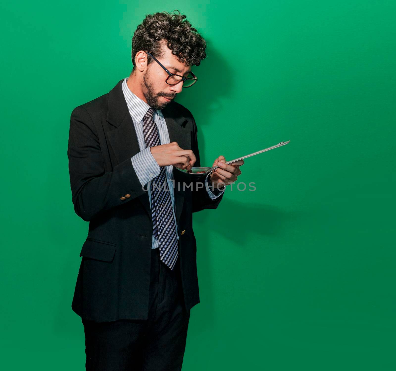 Young businessman tasting cooked beans, friendly businessman eating a spoonful of beans