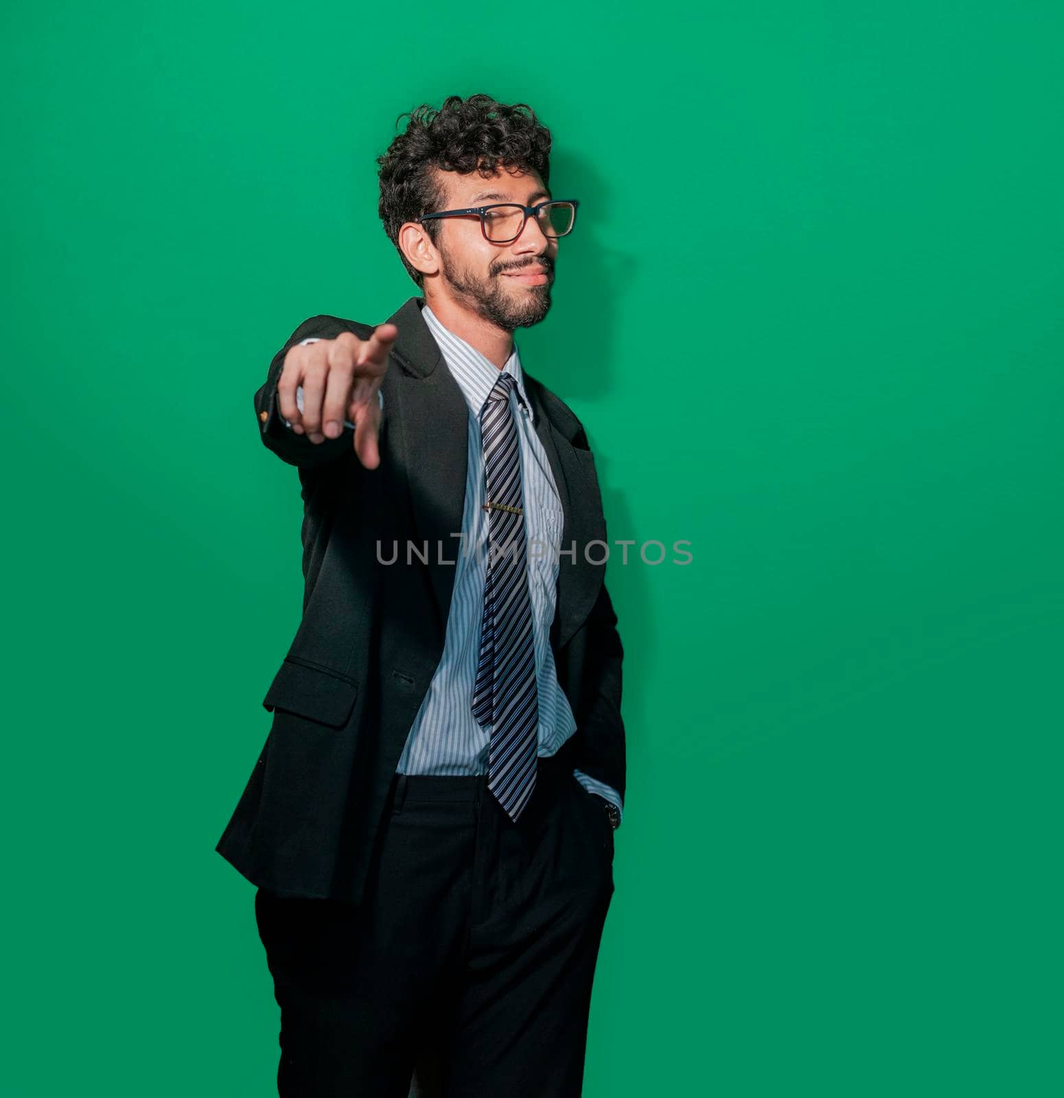 Young businessman with positive attitude, friendly entrepreneur pointing by isaiphoto
