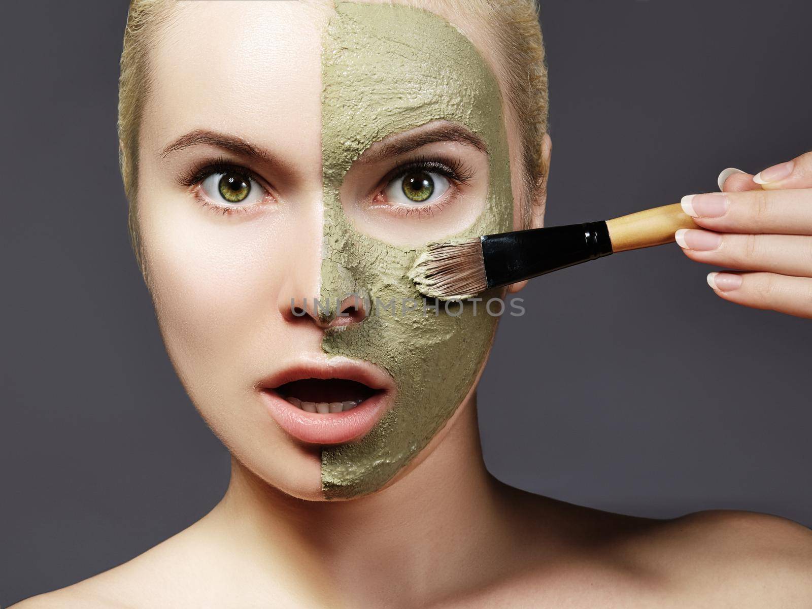 Beautiful Woman Applying Green Facial Mask. Beauty Treatments. Close-up of Spa Girl Apply Clay Facial mask with Brush by MarinaFrost