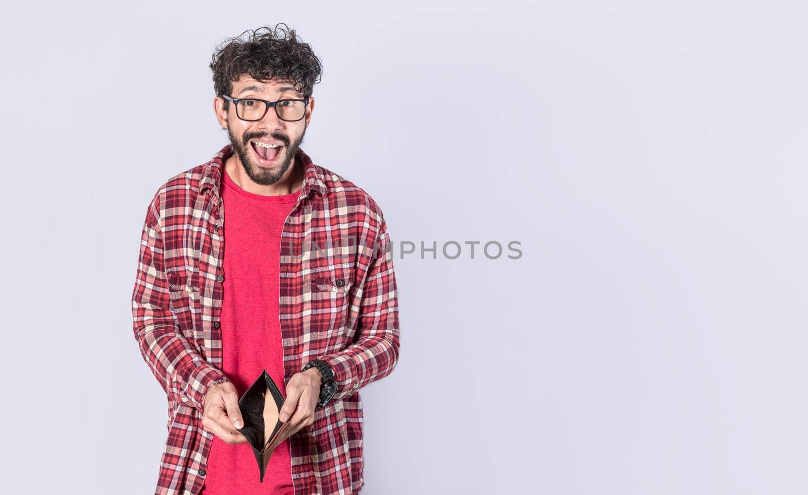 unhappy and surprised man looking in an empty wallet, man seeing his empty wallet, young man with wallet without money