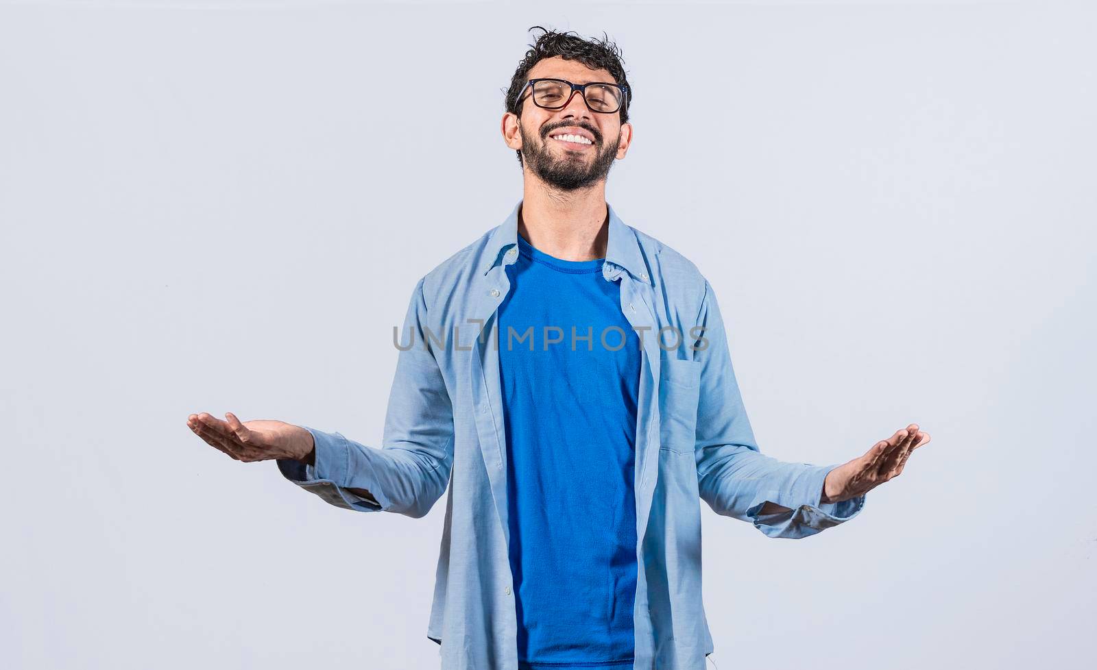 Generous man with open arms, Man sharing open hands looking at the camera with a friendly smile, Man welcoming head-on