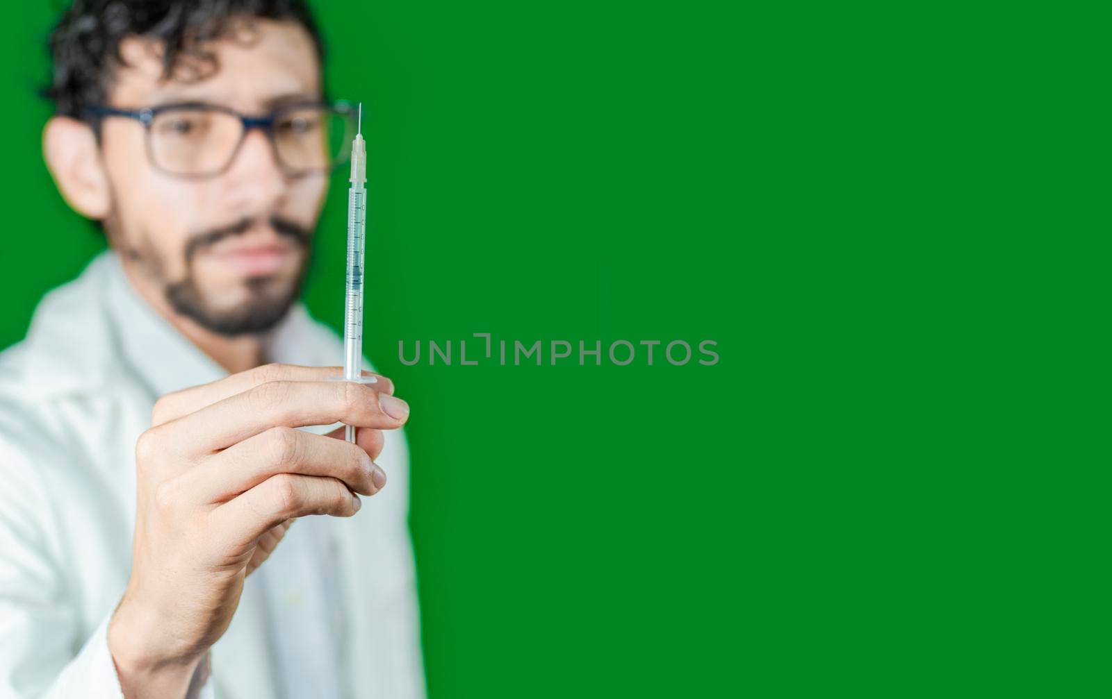Close-up of a doctor's hand holding a syringe, Close-up of a hand holding an injection on an isolated background, Doctor and syringe concept