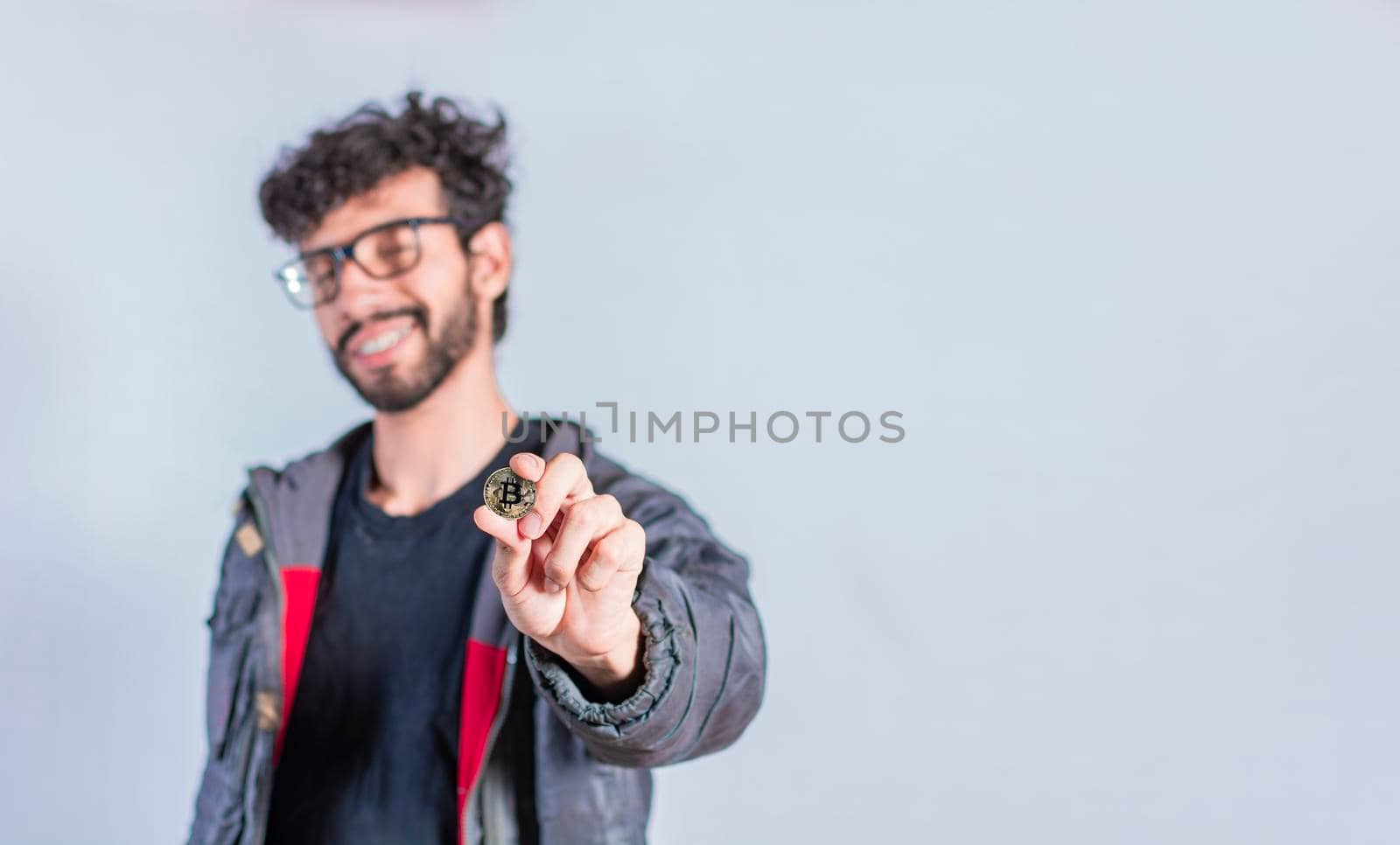 Man holding bitcoin coin, Close up of a guy holding bitcoin coin, concept of entrepreneurship and investment with bitcoin