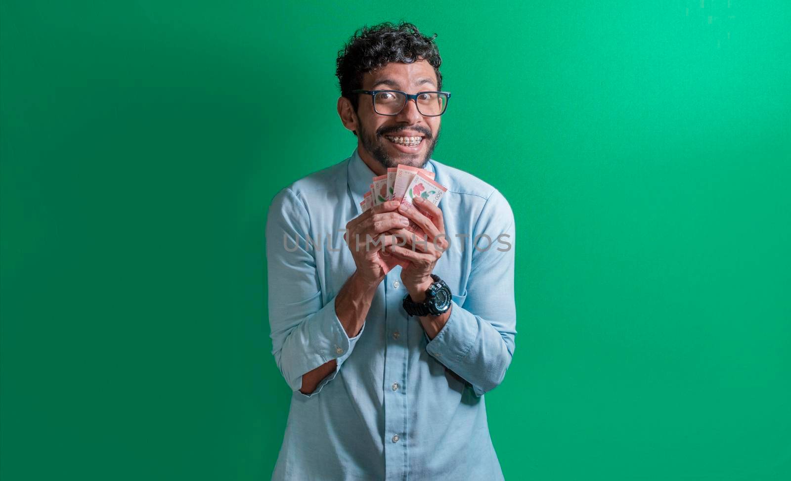 Excited man with money in his hands, Latin guy excited with money in his hands
